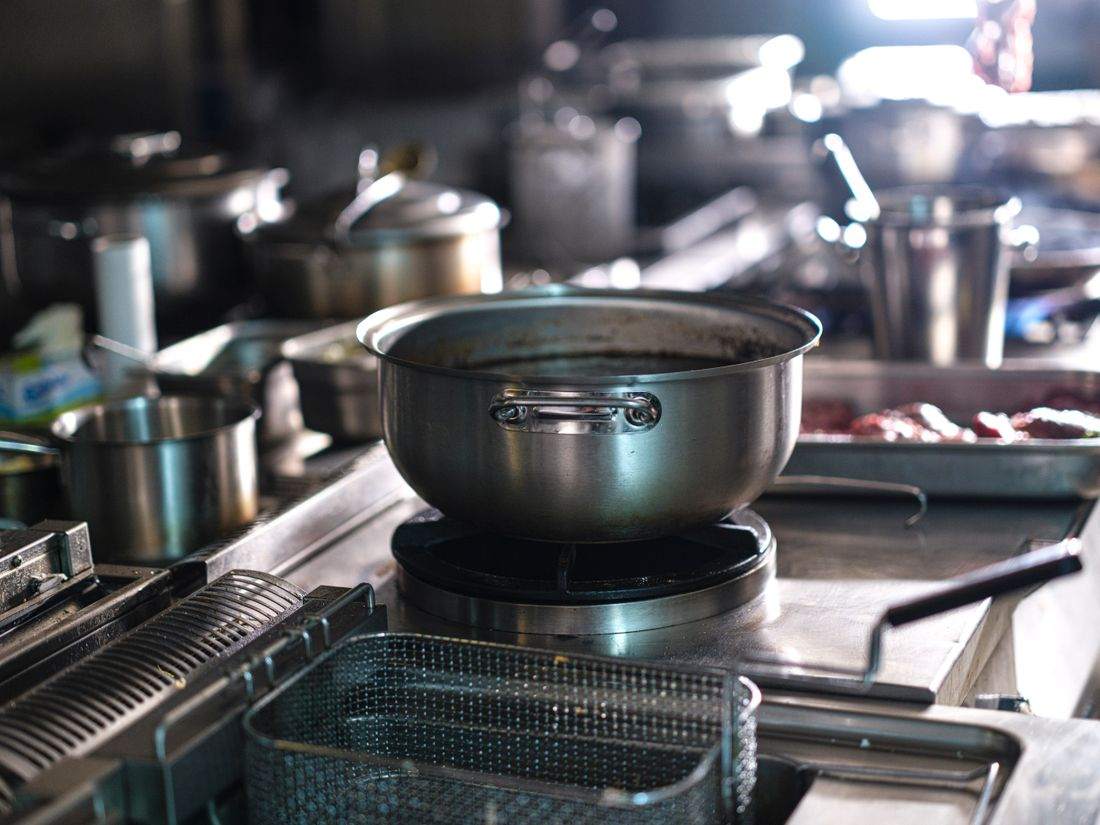 A stainless steel pot on a commercial burner