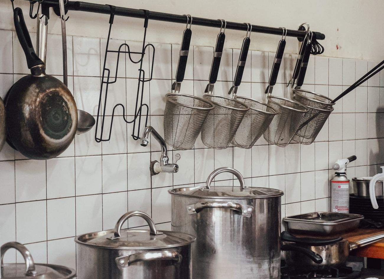 Stainless stock pots, strainers and pans in a commercial kitchen