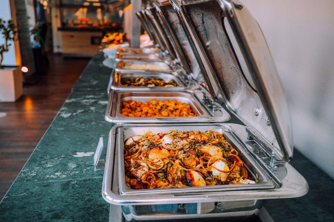 A line of stainless steel food warmers