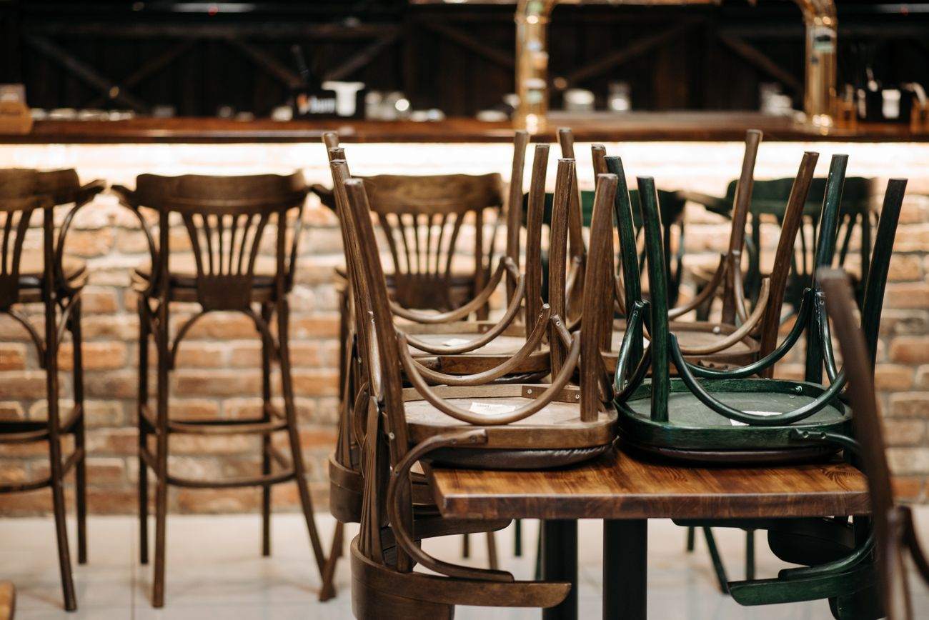 Chairs stacked on tables in a restaurant after closing