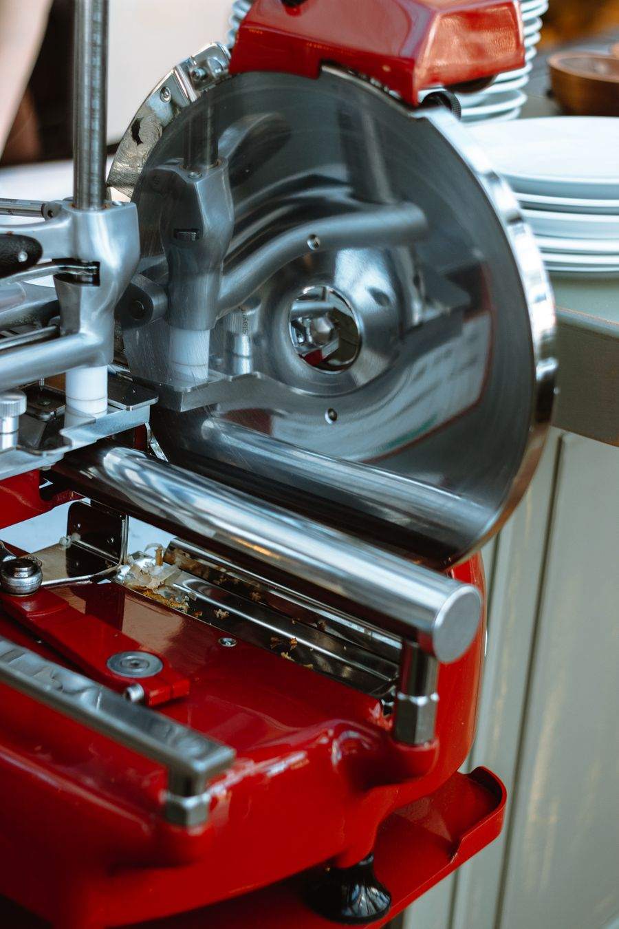 A commercial meat slicer with a round steel blade